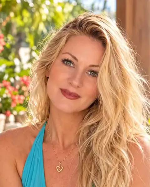 Birgit Waites, M.S., smiling, in a turquoise top